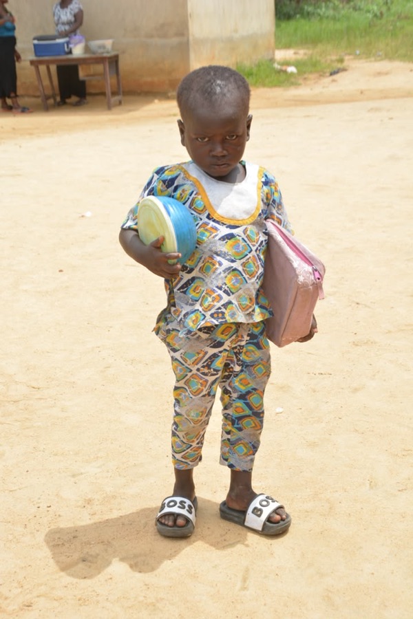 Young student carrying learning materials